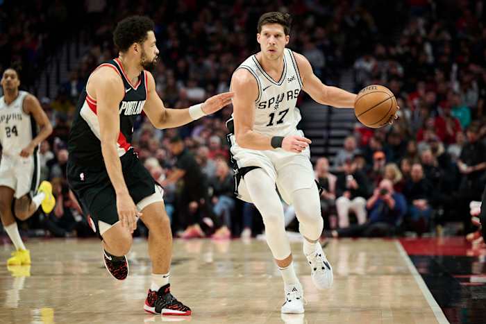 Dec 28, 2023; Portland, Oregon, USA; San Antonio Spurs forward Doug McDermott (17) dribbles the ball during the second half against Portland Trail Blazers guard Skylar Mays (5) at Moda Center.